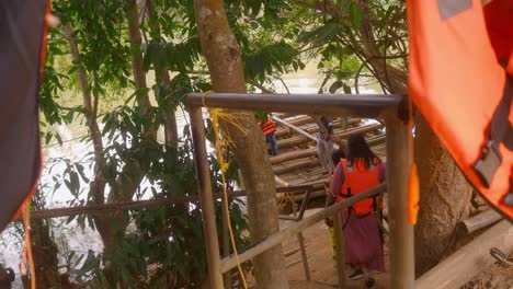 Women-wearing-life-vests-embark-on-a-bamboo-raft-adventure