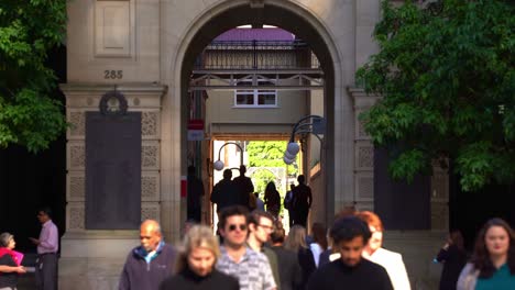 Lunch-time-rush-hours-capturing-large-crowds-of-office-workers-crossing-GPO-laneway-between-Queen-and-Elizabeth-street,-static-shot-with-the-archway-of-GPO-heritage-listed-buildings-in-the-background