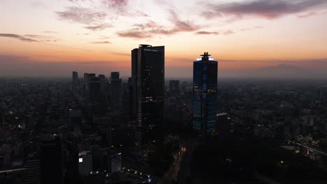 Drone-shot-toward-the-Ritz-Carlton-hotel-and-the-BBVA-tower,-dusk-in-Mexico-city