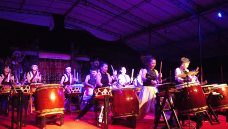 Musicians-Play-Taiko-Drums-Percussion-Live-Energetically-Onstage-Asian-Culture-Traditional-Instruments