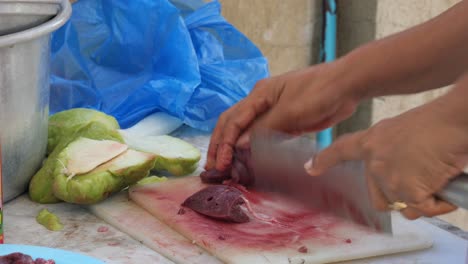 April,-22-2023,-Danao-City,-Cebu,-Philippines---Woman-Cutting-Pork-Liver-Preparing-Ingredients-for-a-Traditional-Filipino-Dish