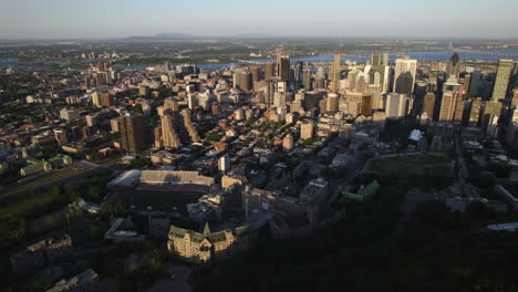 Aerial-view-of-the-Percival-Molson-Memorial-Stadium-and-downtown-Montreal,-sunset-in-Quebec,-Canada