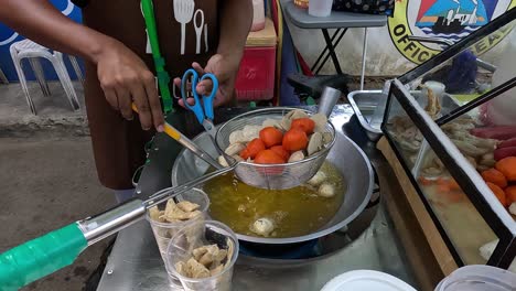 Street-Food-Vendor-in-Cebu,-Philippines,-Preparing-a-Tradional-Filipino-Street-Food-Dish---Tempura-and-Fish-Balls