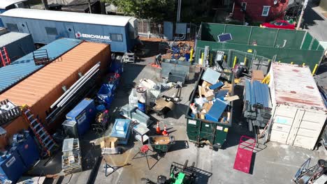 Aerial-view-showing-Benchmark-Construction-company-in-Lancaster-City-with-container-filled-with-garbage-and-scarp,-America