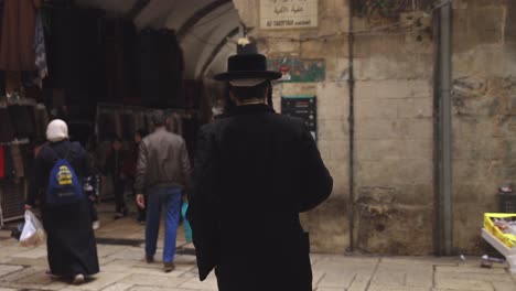 Religious-Jewish-Man-Leaves-Synagogue,-Walks-Through-Old-City-Jerusalem