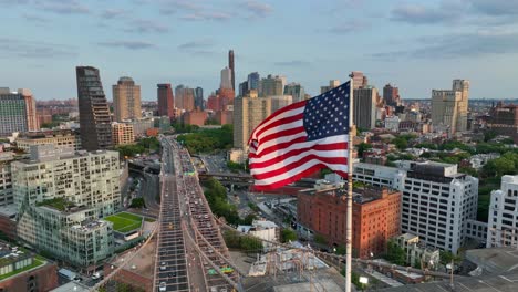 American-flag-with-Brooklyn,-New-York-skyline-in-background
