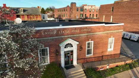 Drone-view-of-a-United-States-Post-Office-in-downtown-of-a-small-community-in-America-at-sunset-in-the-springtime