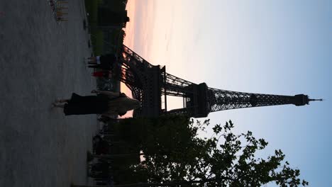 Silueta-De-Mujer-Caminando-Hacia-La-Torre-Eiffel-Al-Atardecer,-Vertical