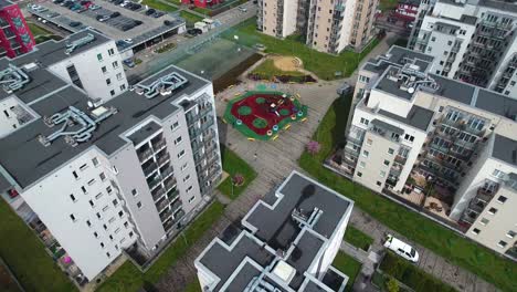 New-secure-residential-complex-with-a-sports-field,-playground,-sandbox,-and-parking-lots-during-spring-in-Poland