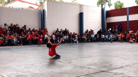 Young-boy-being-happy-and-excited-because-he-made-a-goal-in-the-football-match-in-the-outdoor-school