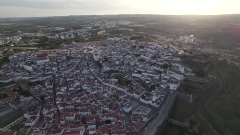 Aerial:-mesmerizing-charm-of-Elvas-at-sunset,-cityscape-and-landscape,-Portugal