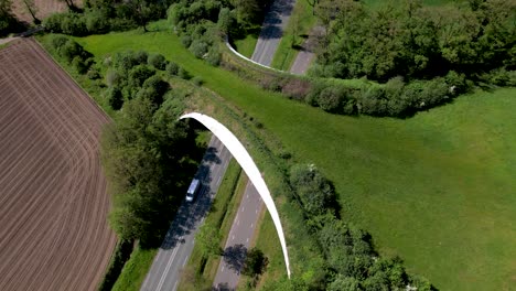 Steady-aerial-view-of-a-large-wildlife-crossing-forming-a-safe-natural-corridor-bridge-for-animals-to-migrate-between-conservancy-areas