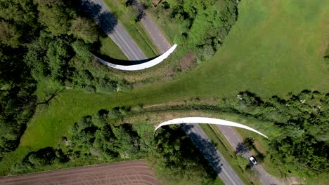 Dutch-angle-aerial-steady-frame-of-a-large-wildlife-crossing-forming-a-safe-natural-corridor-bridge-for-animals-to-migrate-between-conservancy-areas