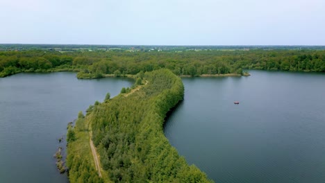 Road-in-the-middle-of-Surfstek-Lake,-The-Netherlands,-Aerial-view