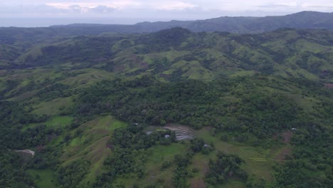 Amazing-green-scenery-with-rice-paddies-at-Sumba-island,-aerial
