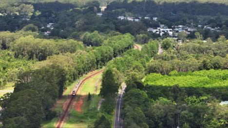 Rural-Train-Traveling-Through-Green-Scenic-Australian-Countryside,-4K-Drone-Flyover