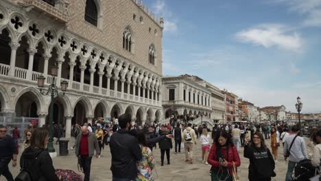 Touristen,-Die-Um-Den-Dogenpalast-Herumlaufen,-Mit-Der-Ponte-Della-Paglia-Im-Hintergrund