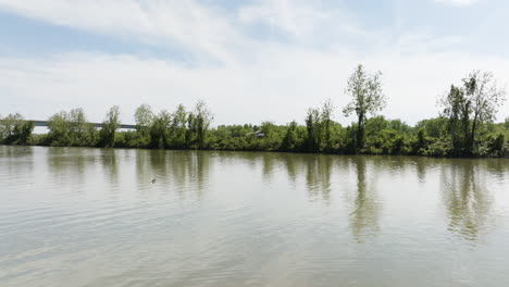 Tranquil-Waters-Of-Arkansas-River-With-Green-Trees-In-Daytime
