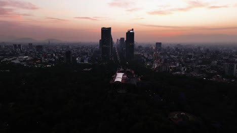 Drone-shot-of-the-Castillo-de-Chapultepec-and-silhouette-highrise-of-Mexico-city