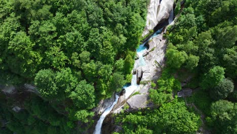 Aerial-top-down-circling-view-of-scenic-Foroglio-Waterfall-In-Bavona-Valley,-Switzerland