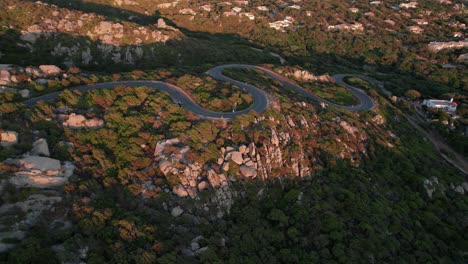 Road-running-over-pink-rocks-and-vegetation