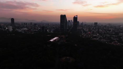 Aerial-view-around-the-Chapultepec-castle-and-silhouette-highrise,-dusk-in-Mexico-city---wide,-danoramic,-orbit,-drone-shot