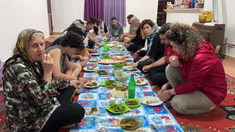 A-family-dining-ceremony-gathering-sitting-around-the-table-is-popular-in-middle-east-Asia-Emirates-Persian-Saudi-Arabia-people-wonderful-night-eating-delicious-food-cuisine-experience-travel-tasty