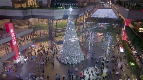 Aerial-top-down-shot-of-lighting-christmas-tree-in-shopping-center-of-Taipei-City-at-night