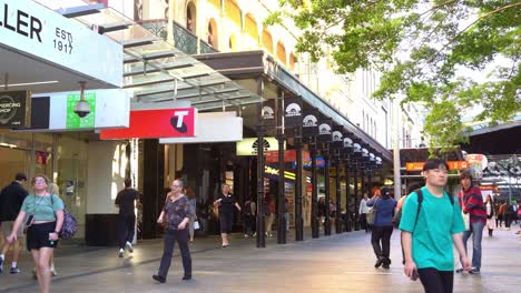 Bustling-downtown-Brisbane-city-at-Queen-street-mall-with-people-strolling-at-the-outdoor-pedestrian-shopping-mall,-Myer-closing-down-sale-at-namesake-shopping-centre,-static-shot