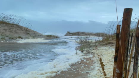 Flood-waters-from-aftermath-of-hurricane-storm-surge-on-beach,-POV