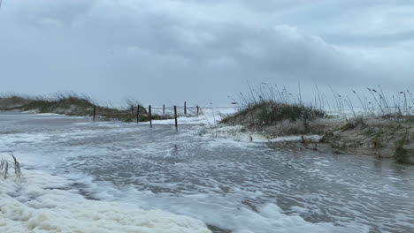 Aftermath-of-Category-4-hurricane-surge-water-flooding-beach-and-access-walkway