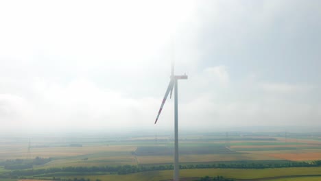 Windmill-Covered-In-Fog-In-Weinviertel,-Austria---aerial-shot