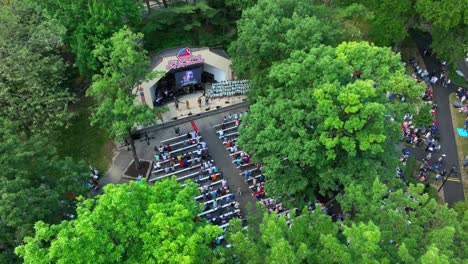 Aerial-panoramic-view-of-Lititz-Springs-Park-fourth-of-July-celebration-outdoor-performance-of-a-choir-performing-for-the-community-members-on-a-beautiful-Sunday-afternoon