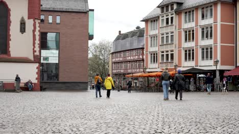 People-Walking-Across-Romerberg-Square-Towards-Fahrtor-1-Street-Leading-To-Eiserner-Steg