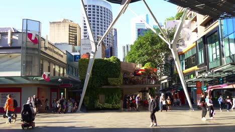 Busy-foot-traffics-at-the-intersection-of-Queen-Street-and-Albert-Street-at-the-centre-of-the-mall-with-a-15-metre-high-steel-structure-designed-to-provide-shade-and-cover,-static-shot