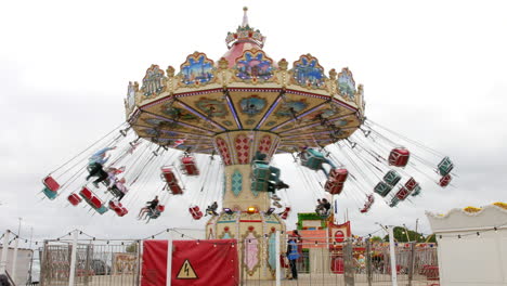Merry-go-round-ride-at-a-vintage-traditional-fairground-fun-fair-carnival-amusement-park