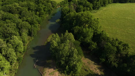 River-Surrounded-With-Lush-Vegetation-In-AR,-USA---aerial-drone-shot