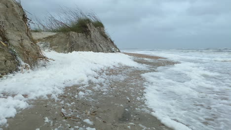 Heavy-winds-blowing-sea-foam-and-sand-dunes-after-hurricane-force-storm-surge