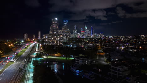 Fast-aerial-hyperlapse-over-busy-Gold-Coast-Highway-at-night,-Queensland