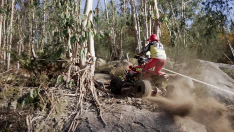 Driver-Wearing-Full-Gear-Jumping-On-ATV-Over-Small-Soil-Peak