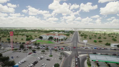 Aerial-during-daytime-over-residential-area-and-traffic-car-crossroads-in-Reynosa,-an-border-city-in-the-northern-part-of-the-state-of-Tamaulipas,-in-Mexico