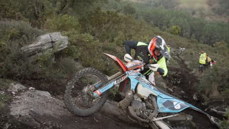 Piloto-De-Motocross-Perdiendo-El-Equilibrio-Intentando-Con-Todas-Sus-Fuerzas-Subir-Una-Colina-Alta