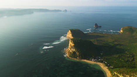Aerial-approaching-shot-of-golden-coastline-named-Gerupuk-surf-spot-in-south-of-Lombok,-Indonesia
