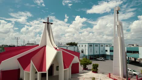 Aerial-view-of-church-San-Pío-X-at-Reynosa,-Tamaulipas,-during-sunny-day,-video-capture-promoting-religious-and-spirituality-concept-and-recording-church-architecture-exterior