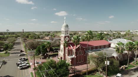 Aerial-view-of-"Our-Lady-of-Guadalup"-Church,-one-of-the-oldest-landmarks-in-Mission,-Texas,-dating-back-to-1899