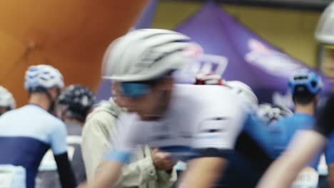 A-man-cheers-on-the-cyclists-surrounding-him-during-the-start-of-the-race