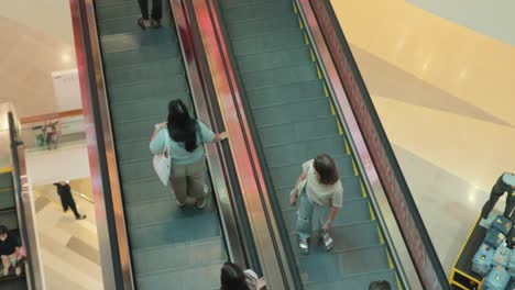 Thai-People-Riding-on-an-Escalator-in-Shopping-Mall-in-Bangkok,-Thailand