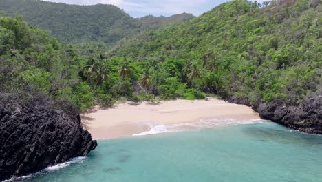Waves-crashing-towards-the-shore-of-Playa-Onda-Samana-In-Dominican-Republic---drone-shot