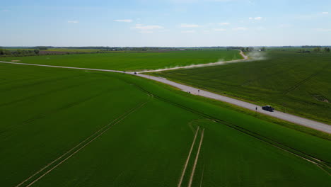 A-drone-flies-over-farms-and-roads-on-a-blue-sky-day