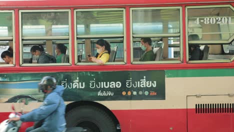 Thai-People-Sitting-on-an-Old-Red-Bus-Traveling-in-Thailand